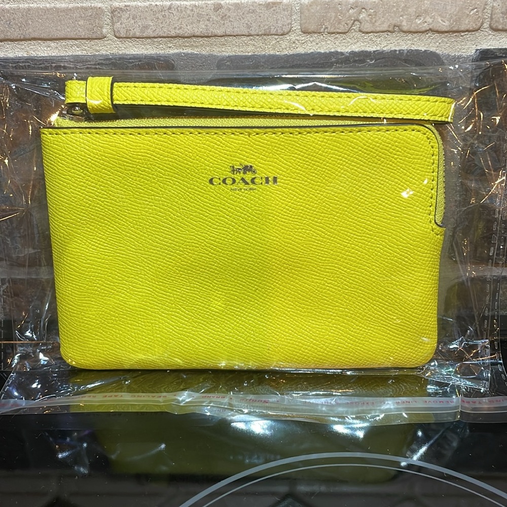 NWT Coach bright yellow Wrislet with two card slots and brown interior